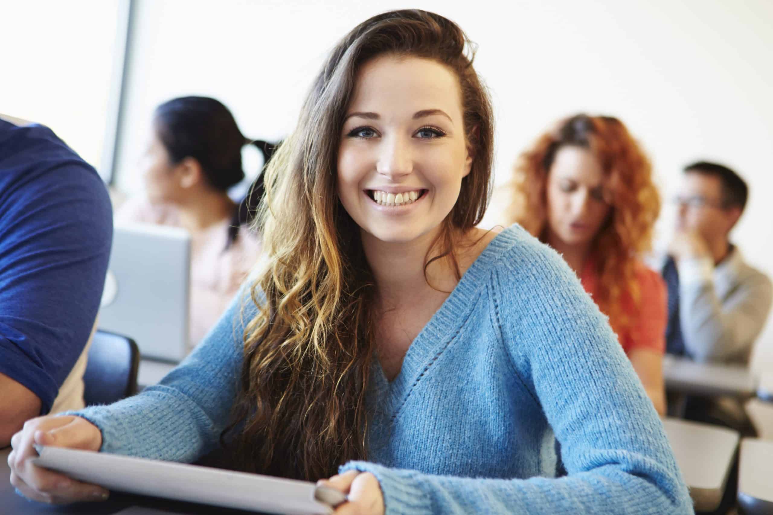 Female University Student Using Digital Tablet In Classroom